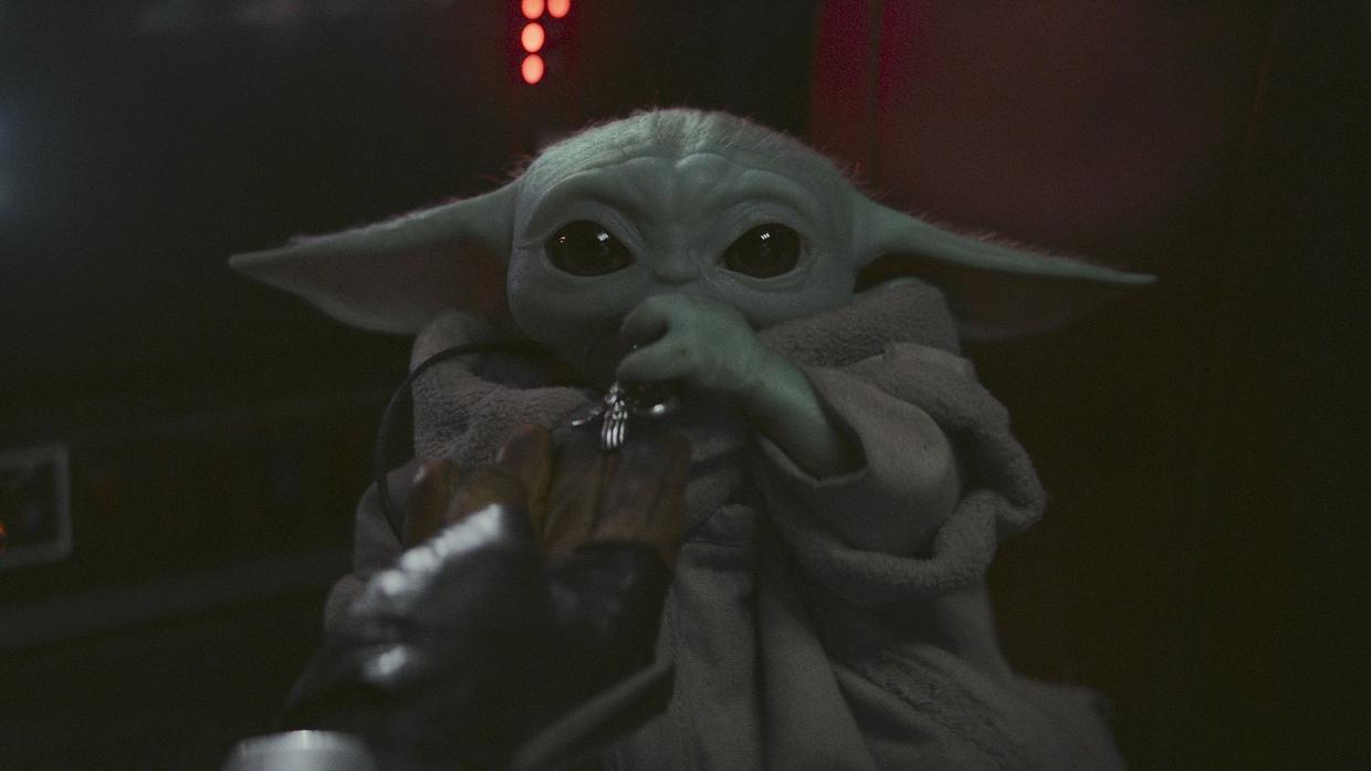 Photo of The Mandalorian cradles Baby Yoda in latest footage from Star Wars spin-off