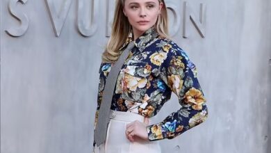 Photo of Chloe Grace Moretz stands out in a floral-print shirt and white pants while attending Louis Vuitton’s 2023 Cruise Show in San Diego